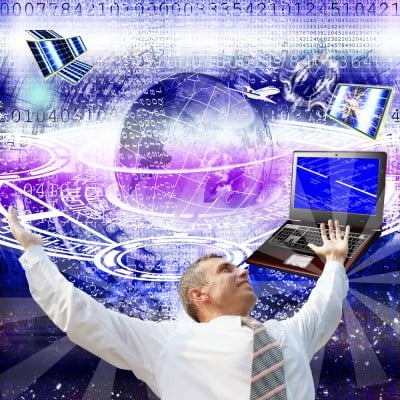 Man with arms up with picture of earth and computers