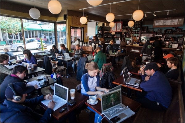 people in coffee shop working on projects